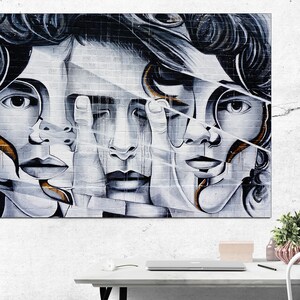May include: Abstract art print featuring four faces with overlapping features, painted in shades of gray and white with hints of gold. The faces are fragmented and layered, creating a sense of depth and mystery.