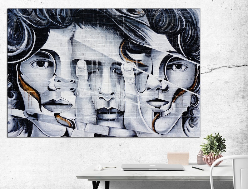 May include: Abstract art print featuring four faces with overlapping features, painted in shades of gray and white with hints of gold. The faces are fragmented and layered, creating a sense of depth and mystery.