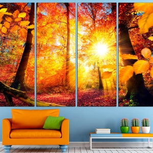 May include: A multi-panel canvas print featuring a vibrant autumn forest scene. The sun shines through the trees, casting golden rays of light on the colorful leaves. The print is perfect for adding a touch of nature to any room.
