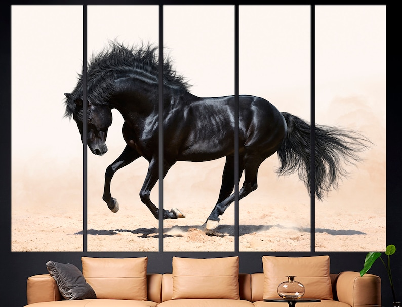 May include: A black horse with a long flowing mane and tail runs across a sandy surface. The horse is in mid-stride with its legs extended. The background is a soft white.