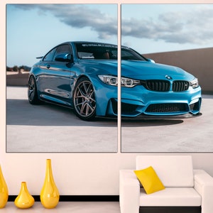 May include: A blue BMW M4 sports car parked on a concrete surface. The car has black wheels and a black front bumper.