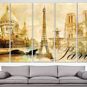 May include: A multi-panel canvas print featuring iconic Parisian landmarks in a vintage style. The print includes the Eiffel Tower, the Sacr&eacute;-C&oelig;ur Basilica, and Notre Dame Cathedral. The word "Paris" is written in a stylized font across the bottom of the print.
