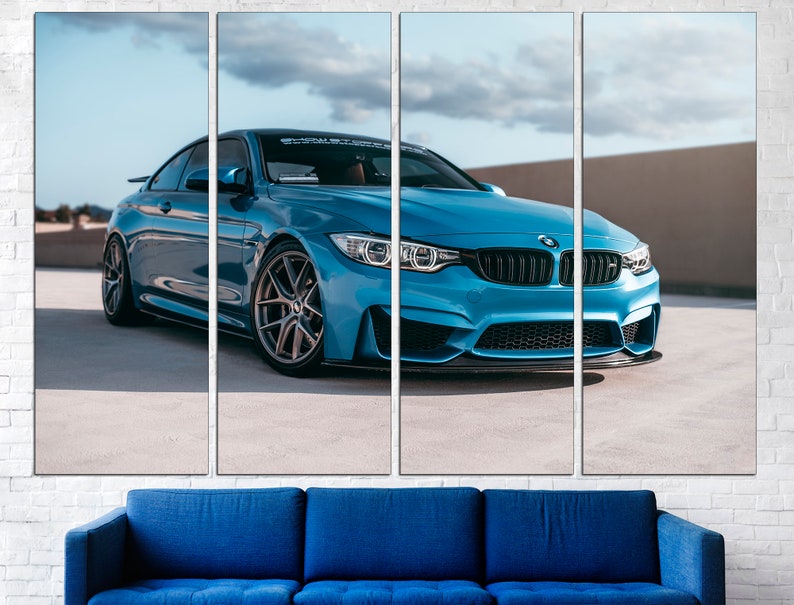 May include: A blue BMW M4 sports car parked on a concrete surface. The car has black wheels and a black front bumper.