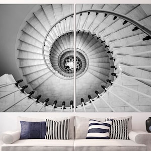 May include: A black and white photograph of a spiral staircase with a white railing. The staircase is made of marble and has a very intricate design.