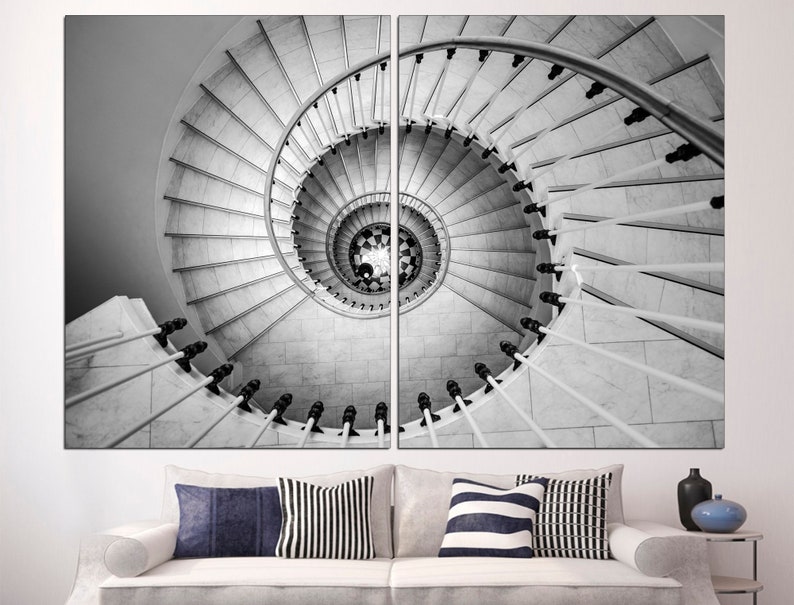 May include: A black and white photograph of a spiral staircase with a white railing. The staircase is made of marble and has a very intricate design.