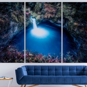 May include: A tri-panel canvas print featuring a waterfall cascading into a deep blue pool surrounded by lush greenery. The image is taken from a high angle, giving a dramatic perspective of the natural scene.