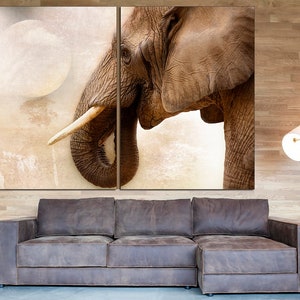 May include: A close-up of an elephant's head and trunk, with a soft, faded background. The elephant's skin is textured and brown, and its tusks are long and white.