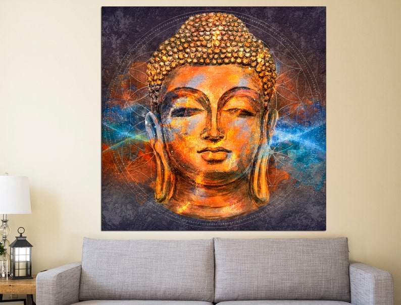 May include: A large square canvas print featuring a detailed, colorful depiction of a Buddha head. The artwork uses orange, blue, and gold tones, with a textured appearance. The background is dark with geometric patterns.