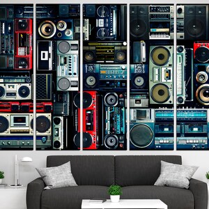 May include: A multi-panel wall art print featuring a collage of vintage boomboxes and cassette players in various colors and styles. The print is made up of five panels, each with a different arrangement of boomboxes. The boomboxes are all in different colors, including red, blue, green, and black. The print is a great way to add a retro touch to any room.