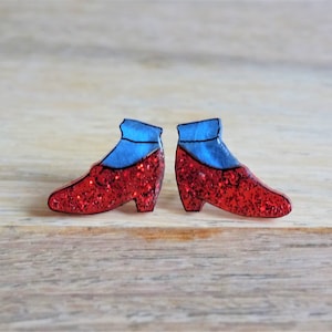 May include: A pair of red glitter ruby slipper earrings with blue glitter socks.