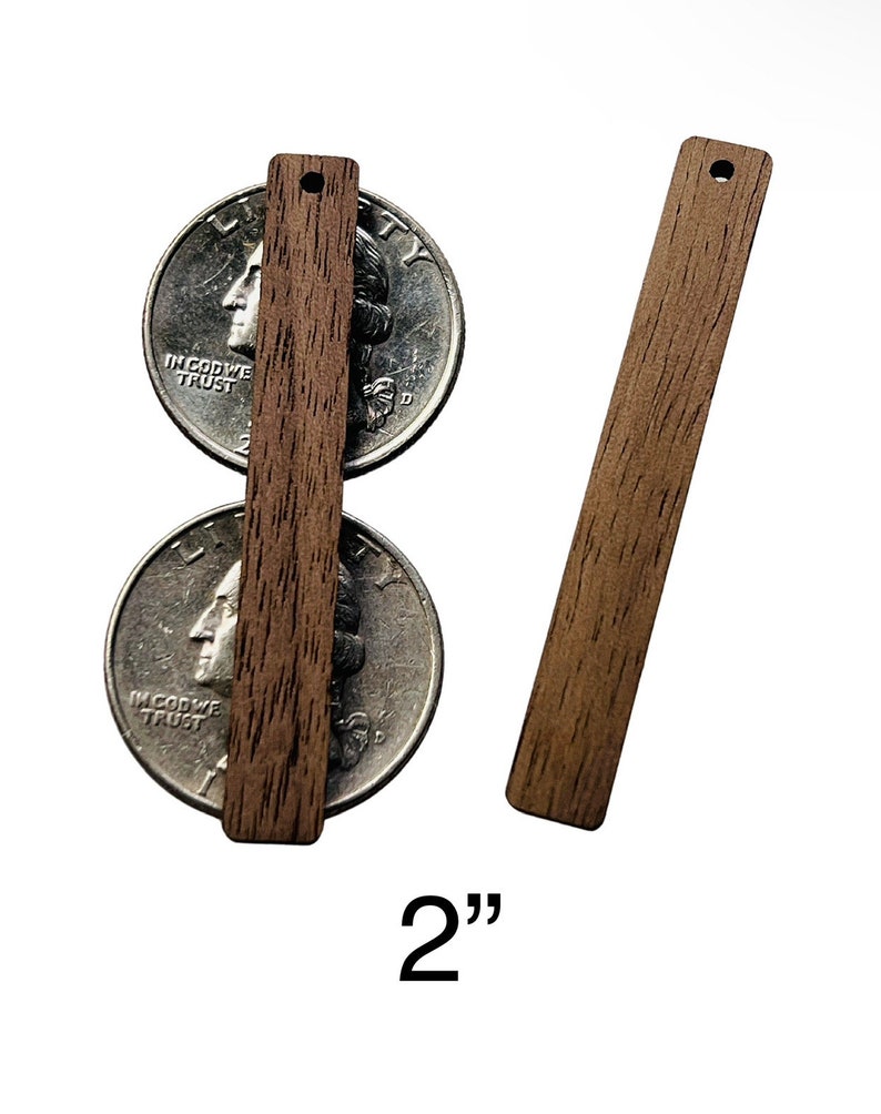 May include: Two rectangular wooden pieces, each with a small hole at the top, are displayed. One is positioned over two quarters, and the other is to the right. The text "2"" is at the bottom, indicating the length of the wooden pieces.
