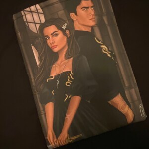 May include: A painting of a couple in black clothing standing in front of a window. The woman has long dark hair and is holding a sword. The man has short dark hair and is wearing a gold necklace. The background is a dark grey.