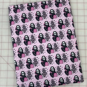 May include: Pink fabric with a repeating pattern of a black and white Ghostface mask holding a pink telephone. The text "NO YOU HANG UP" is above the phone. The fabric is on a grid.