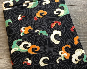 Könnte beinhalten: Schwarze Laptoptasche mit einem sich wiederholenden Muster aus stilisierten Wellen in den Farben Türkis, Orange, Weiß und Gold auf schwarzem Hintergrund.