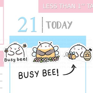 May include: Three cartoon bee stickers with the text "Busy bee!" The stickers are white with black outlines and feature bees with various designs, including a bee carrying a flower and a bee with a beehive. The text "Less than 2.5 cm tall" is at the top.