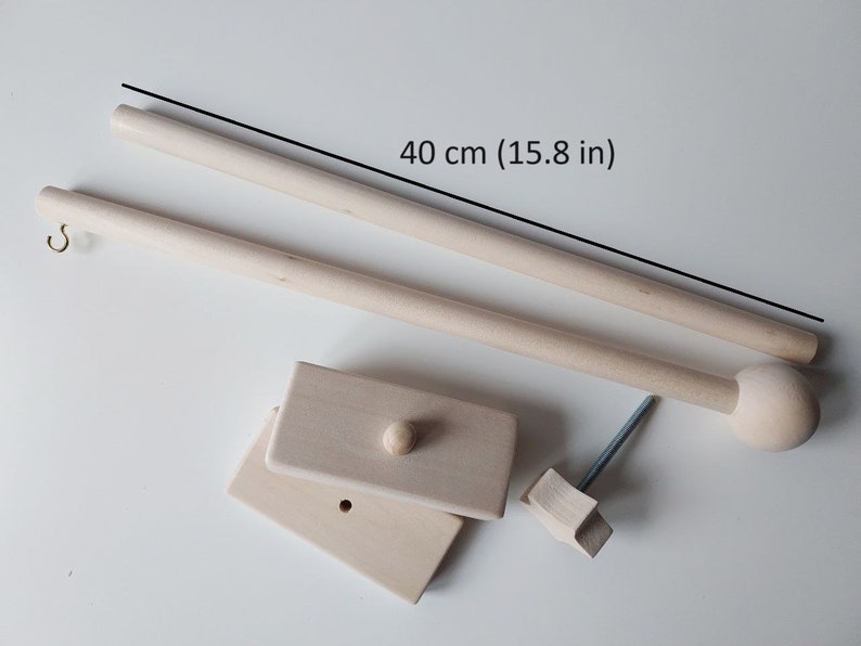 May include: A set of wooden dowels for hanging macrame or other crafts. The dowels are 40 cm (15.8 in) long and come with a hook, a knob, and a wooden base.
