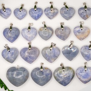 May include: A collection of 18 blue lace agate heart pendants with silver bail. The pendants are all different shapes and sizes, but they are all heart-shaped.