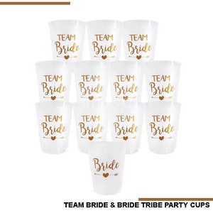 May include: Set of 10 clear plastic party cups with gold lettering. The cups say "Team Bride" and "Bride".