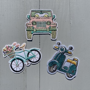 May include: Three embroidered iron-on patches featuring a pink jeep, a green bicycle with flowers in the basket, and a green scooter.