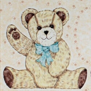 May include: A light brown teddy bear with a blue bow sitting on a light brown background with brown paw prints. The bear is waving with its right paw.