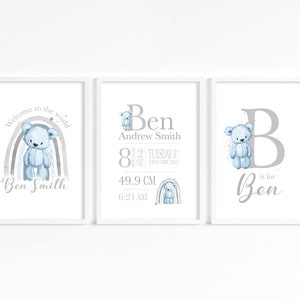 May include: Three printable nursery art prints featuring a blue teddy bear, a rainbow, and a letter B. The prints are in a white frame and have a gray background. The text on the prints reads "Welcome to the world", "Ben Andrew Smith", "8 lbs 2 oz", "Tuesday 8th January 2023", "49.9 cm", "6:21 AM", "B is for Ben".