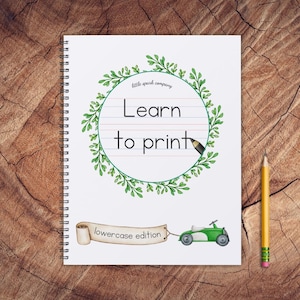 May include: A spiral-bound notebook with the text "Learn to print" inside a green wreath. Below the text is a banner that reads "lowercase edition". A green and white toy car is pulling the banner. A yellow pencil is on the right.