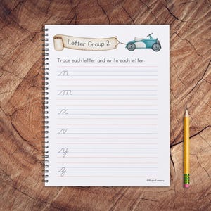May include: A spiral bound notebook with a blue and white toy car illustration on the cover. The notebook has lined pages and the text "Letter Group 2" and "Trace each letter and write each letter" on the cover. The letters "m", "x", "v", "y", and "z" are written on the page.