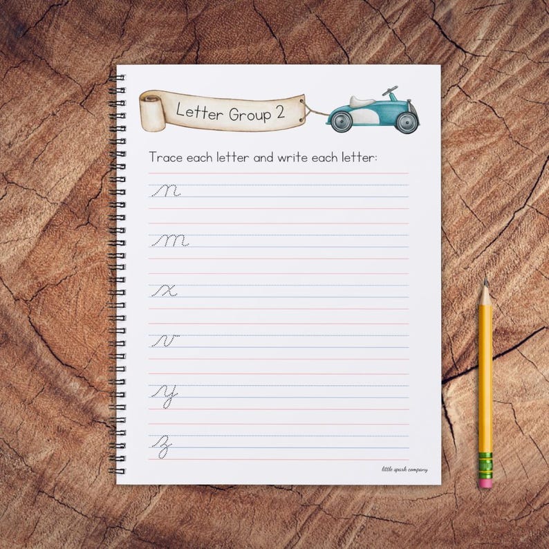 May include: A spiral bound notebook with a blue and white toy car illustration on the cover. The notebook has lined pages and the text "Letter Group 2" and "Trace each letter and write each letter" on the cover. The letters "m", "x", "v", "y", and "z" are written on the page.