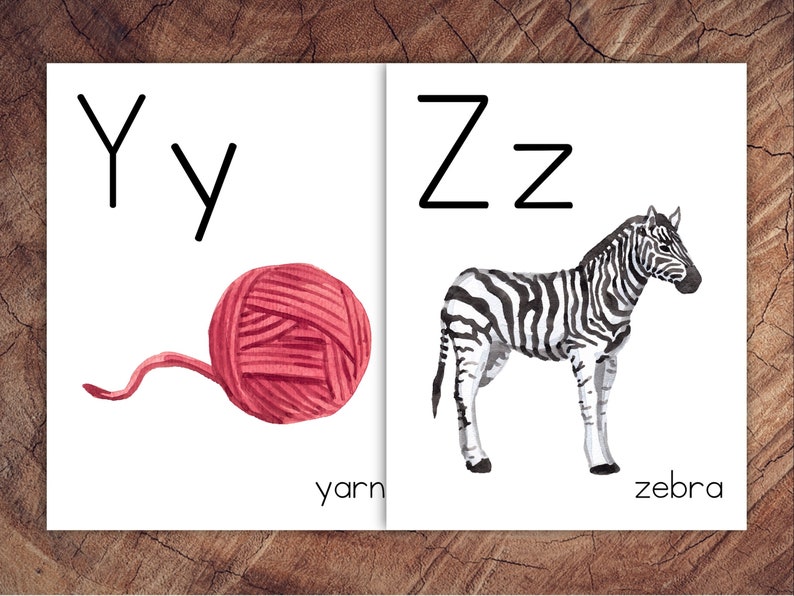 May include: A printable alphabet flashcard with the letter Y and a ball of yarn. The word "yarn" is written below the image. The letter Z and a zebra are on the right side of the card. The word "zebra" is written below the image.