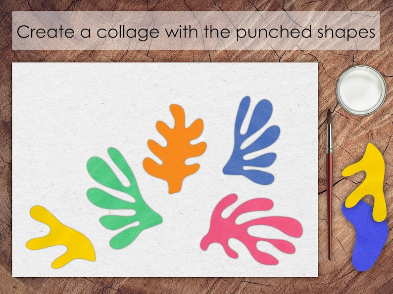 May include: A white sheet of paper with five colorful paper shapes cut out in the shape of leaves. The shapes are orange, green, blue, pink, and yellow. The paper is on a wooden surface.