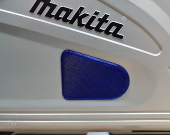 May include: A silver tool case with the Makita logo and a blue plastic button.
