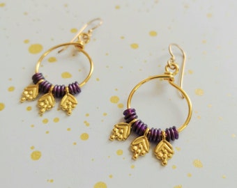 Elegant gold hoop earrings with colorful glass beads and berry charms