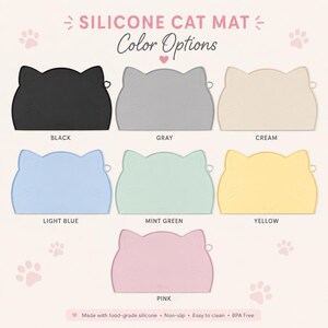 May include: A collection of seven cat-shaped silicone mats in black, gray, cream, light blue, mint green, yellow, and pink. The text reads SILICONE CAT MAT, Color Options, and Made with food-grade silicone, Non-slip, Easy to clean, BPA Free.