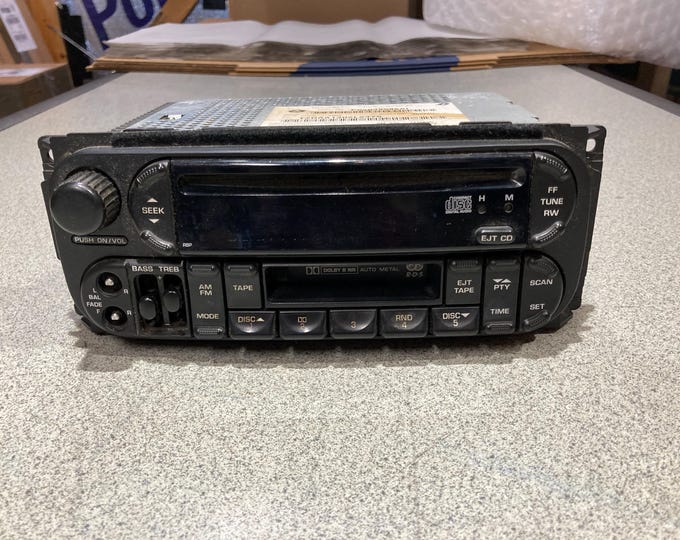 Chrysler Corp. am/fm Stereo, CD & Cassette Factory Car Radio. ( Missing Balance Knobs)  Part No. P56038586AI. Untested...Selling As Is.