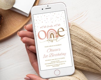 May include: A digital invitation for a first birthday party with a pink and brown rainbow design. The text reads "ant she lovely, went she one derful" and "Olivia's 1st Birthday".