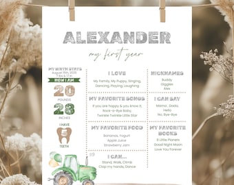 May include: A personalized baby milestone poster with the name "ALEXANDER" in silver glitter lettering. The poster includes the baby's birth stats, favorite things, and a green tractor illustration. The baby weighed 20 pounds and was 28 inches long.