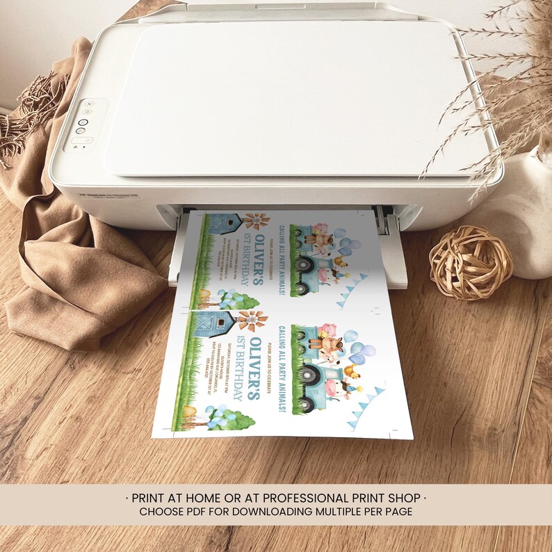 May include: A white printer printing invitations. The invitations feature a blue truck with animal illustrations and the text "Oliver's 1st Birthday". The invitations also include the text "Calling All Party Animals!"