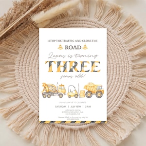 Può includere: Un biglietto d'invito di compleanno rettangolare con grafiche a tema cantiere, inclusi camion gialli, coni stradali e strisce di pericolo nere e gialle. Il testo recita: STOP THE TRAFFIC AND CLOSE THE ROAD, Lucas is turning THREE years old!
