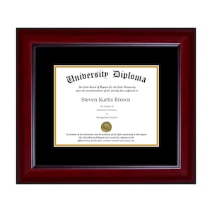 May include: A framed university diploma with a burgundy wooden frame. The diploma is centered on a black mat and features the text "University Diploma" at the top. The diploma is for Steven Kurtis Brown, with a degree in Management Science.