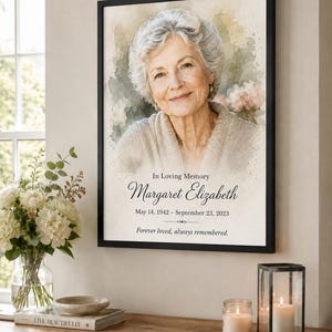 May include: A framed memorial portrait featuring a watercolor-style illustration of an older person with short gray hair. The text reads In Loving Memory, Margaret Elizabeth, May 14, 1942 – September 23, 2023, and Forever loved, always remembered.