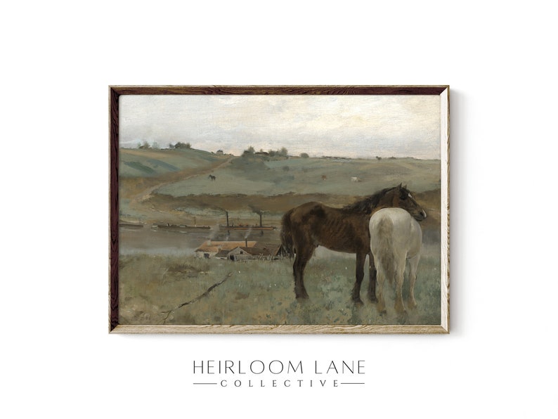 May include: A framed painting of a rural landscape with two horses standing in a field. The horses are brown and white, and they are standing close together. The background of the painting is a rolling green hill with a small village in the distance.