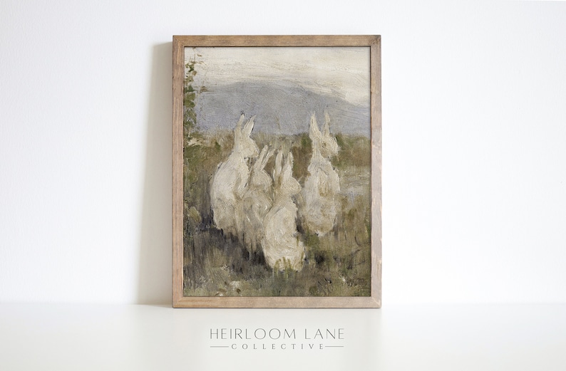 May include: A framed painting of a group of white rabbits in a field. The rabbits are painted in a realistic style, with soft fur and long ears. The background is a blurry landscape of green grass and a blue sky.
