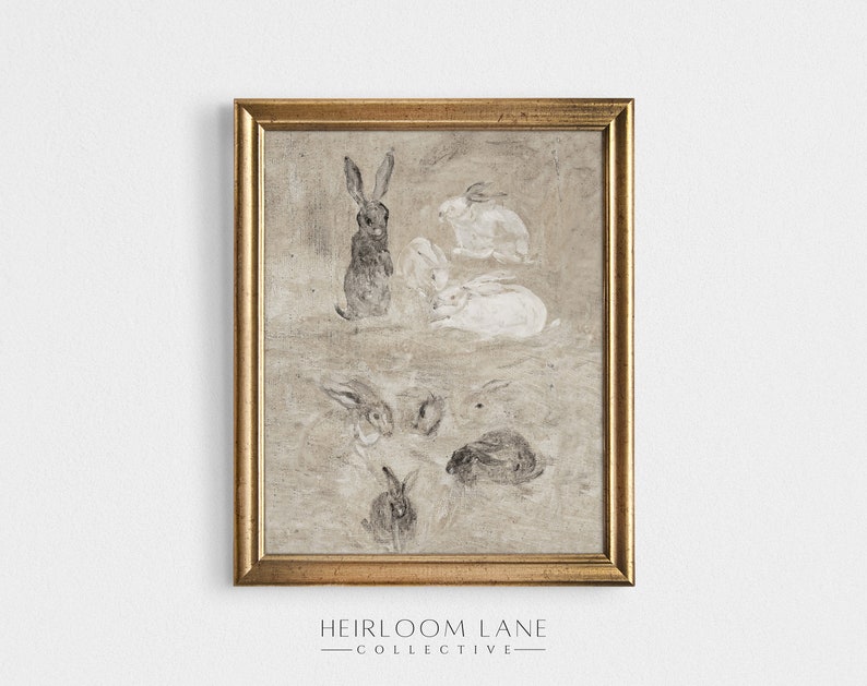 May include: A framed print of a vintage illustration featuring a group of rabbits in various poses. The rabbits are drawn in shades of gray and white on a textured beige background. The frame is gold.
