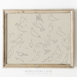 Peut inclure: Une impression encadrée avec un fond beige représentant un dessin minimaliste de plusieurs colombes dans différentes poses. Le texte "HEIRLOOM LANE COLLECTIVE" est imprimé sous l'image.