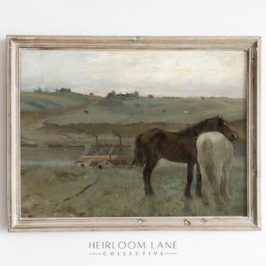 May include: A framed oil painting depicting a rural landscape with two horses standing in a field. The horses are brown and white, and they are standing close together. The background of the painting shows a river, a small village, and rolling hills.
