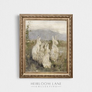 May include: A framed painting of a group of white rabbits in a field. The rabbits are facing different directions and appear to be looking at something in the distance. The background is a hazy landscape with a mountain range in the distance.