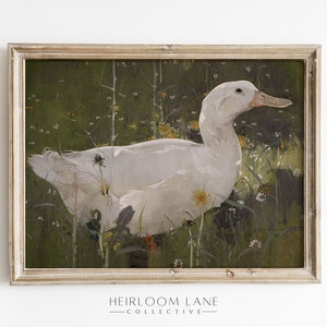 K&ouml;nnte beinhalten: Ein gerahmtes Gem&auml;lde eines wei&szlig;en Enten, das in einem Feld mit gr&uuml;nem Gras und gelben Blumen steht.