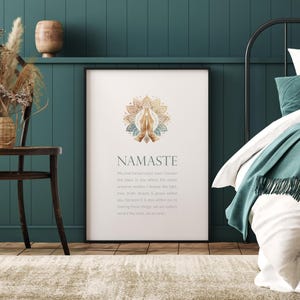 May include: A white printable poster featuring a gold and blue mandala design with the word "Namaste" in large, bold lettering. The poster includes a definition of the word "Namaste" in smaller text.