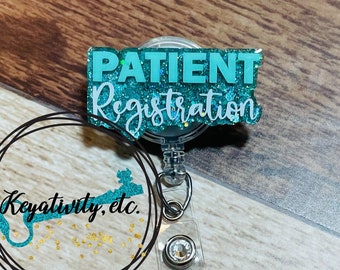 May include: Teal blue glitter badge holder with a clear plastic retractable reel and a silver clip. The badge holder has the text "PATIENT Registration" in white lettering.