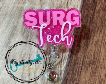 May include: Pink glitter badge reel with the text "SURG Tech" in white lettering. The reel has a clear plastic badge holder and a silver metal clip.